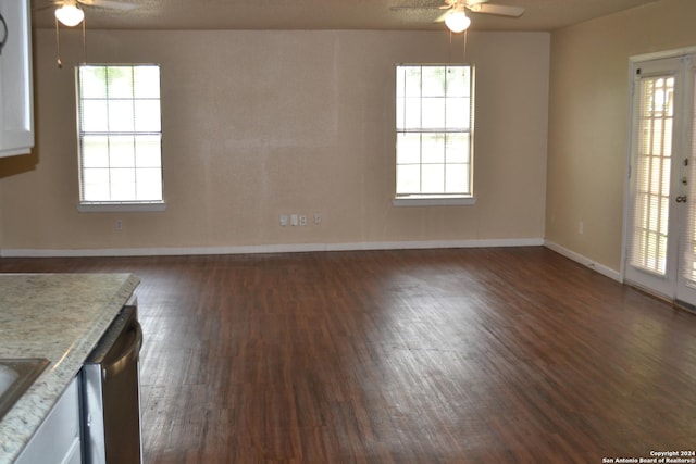 spare room featuring dark hardwood / wood-style floors, a wealth of natural light, and ceiling fan