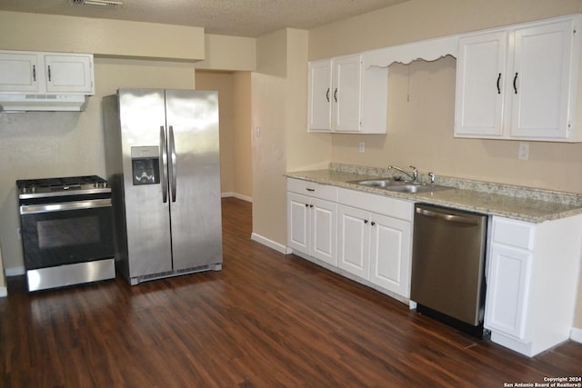 kitchen with ventilation hood, white cabinets, dark wood-type flooring, and appliances with stainless steel finishes