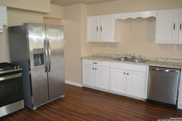 kitchen with dark wood-type flooring, white cabinets, sink, a textured ceiling, and stainless steel appliances