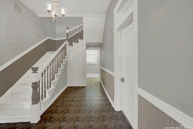 stairs featuring an inviting chandelier