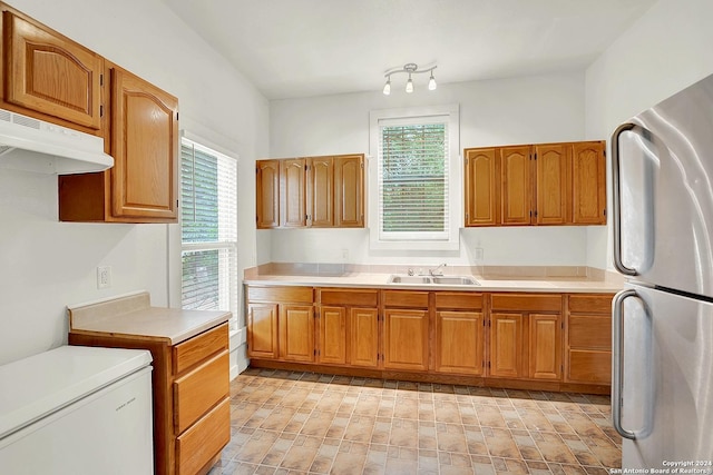 kitchen featuring stainless steel refrigerator, sink, a healthy amount of sunlight, and white refrigerator