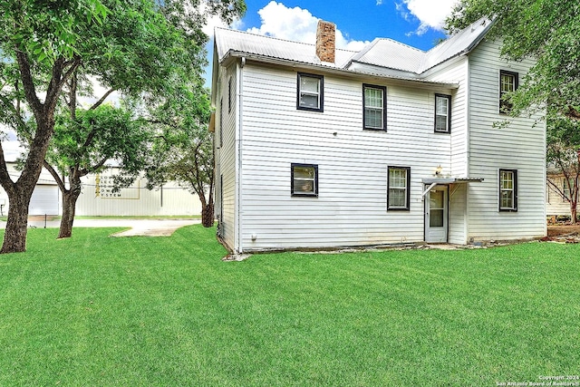 rear view of property featuring a yard