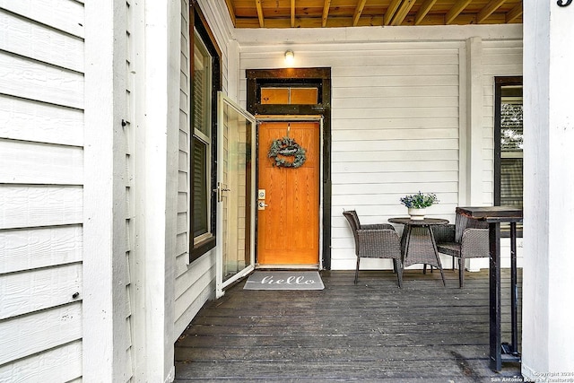 view of exterior entry with covered porch