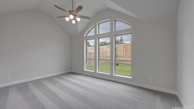 carpeted spare room with vaulted ceiling and ceiling fan