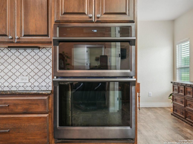 7803 US Highway 181, Falls City, TX 78113 - kitchen view of double oven, baseboards, backsplash, and wood finished floors