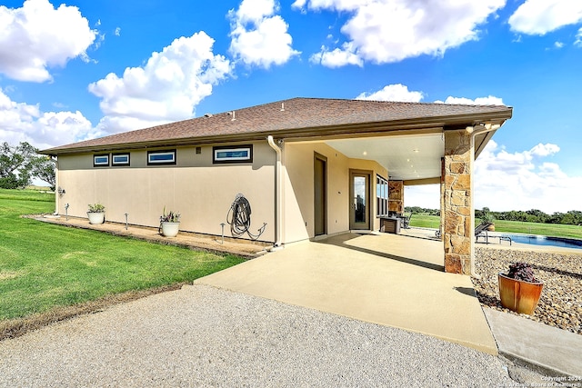 7803 US Highway 181, Falls City, TX 78113 - rear view of property featuring a patio area, a lawn, stucco siding, and driveway