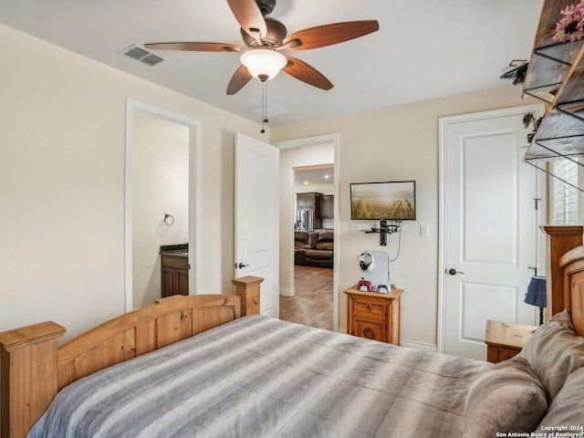 7803 US Highway 181, Falls City, TX 78113 - bedroom featuring baseboards, ceiling fan, and ensuite bath