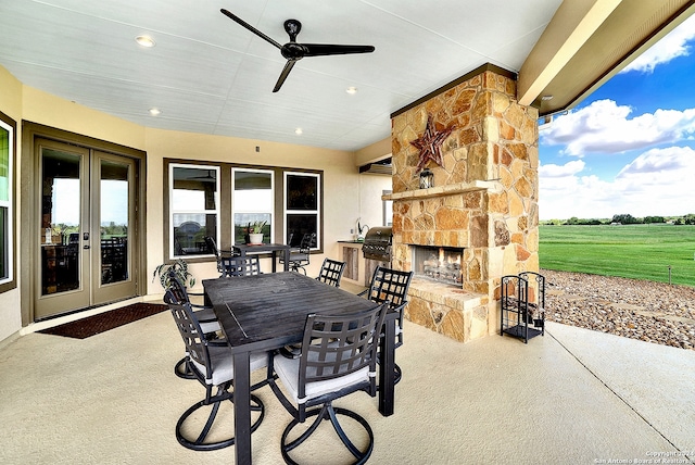7803 US Highway 181, Falls City, TX 78113 - view of patio featuring an outdoor stone fireplace, french doors, outdoor dining space, and a ceiling fan