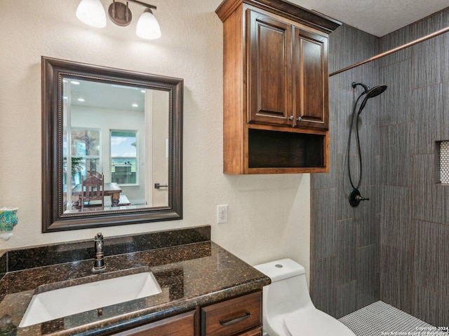 7803 US Highway 181, Falls City, TX 78113 - bathroom featuring a tile shower, toilet, and vanity