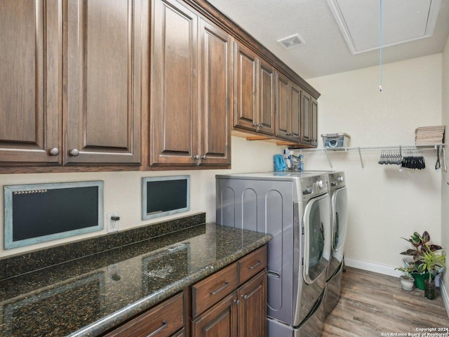 7803 US Highway 181, Falls City, TX 78113 - laundry room featuring attic access, washer and clothes dryer, baseboards, light wood finished floors, and cabinet space