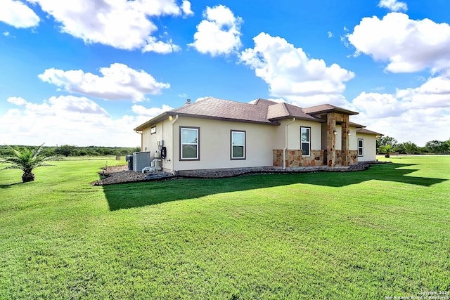 7803 US Highway 181, Falls City, TX 78113 - rear view of property with stucco siding, stone siding, a lawn, central AC, and a shingled roof