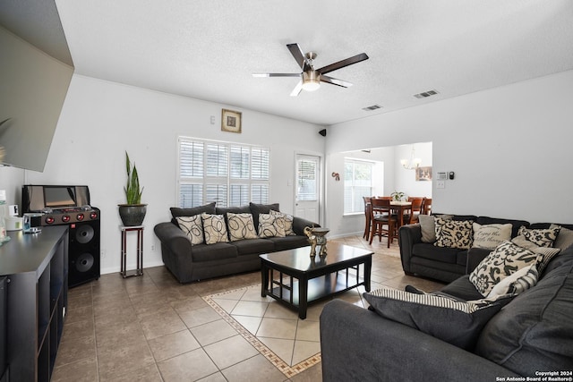 tiled living room featuring ceiling fan and a textured ceiling