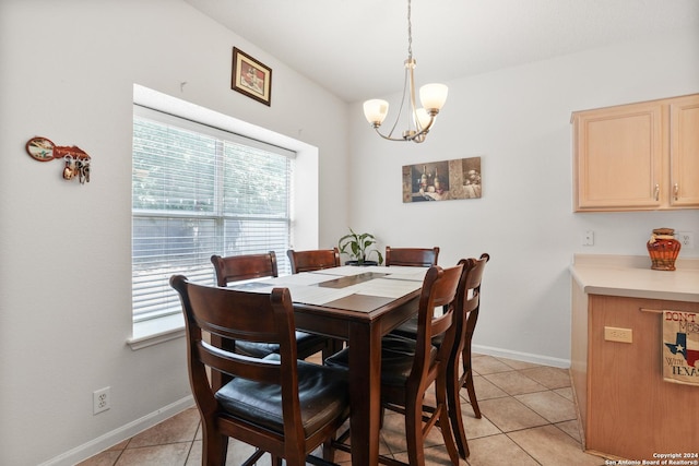 dining space featuring light tile patterned flooring and an inviting chandelier