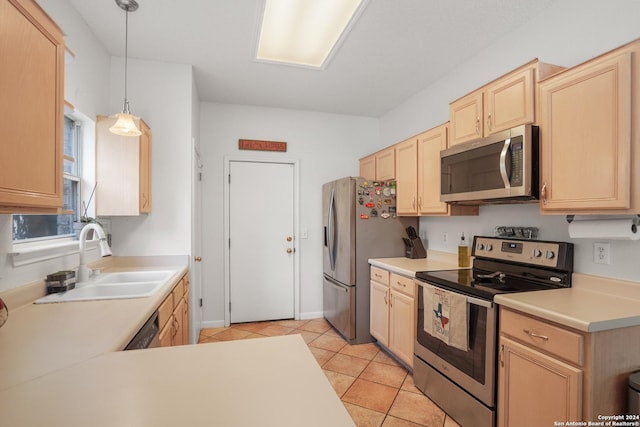 kitchen with sink, hanging light fixtures, light brown cabinetry, light tile patterned flooring, and appliances with stainless steel finishes