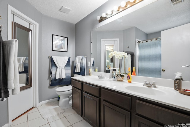 bathroom with a shower with curtain, tile patterned floors, a textured ceiling, toilet, and vanity