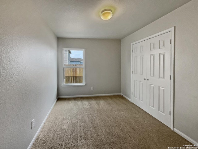 unfurnished bedroom with a closet and carpet