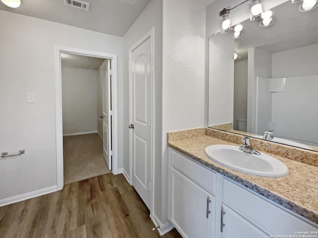 bathroom with hardwood / wood-style flooring and vanity