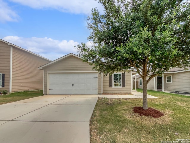 view of front of house with a front yard and a garage