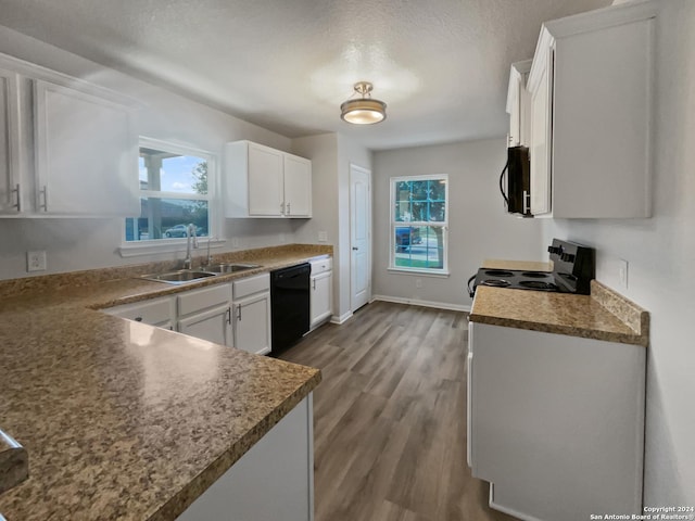 kitchen with white cabinetry, sink, wood-type flooring, a textured ceiling, and black appliances