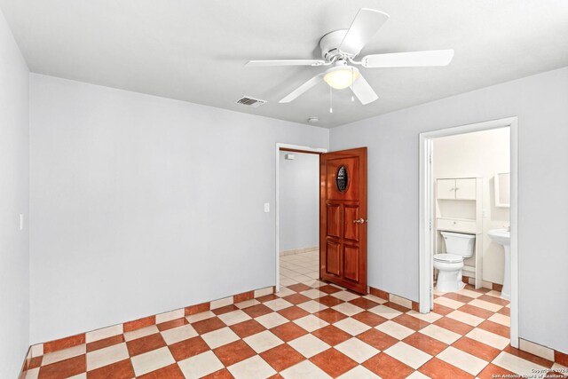 empty room with ceiling fan and light tile floors