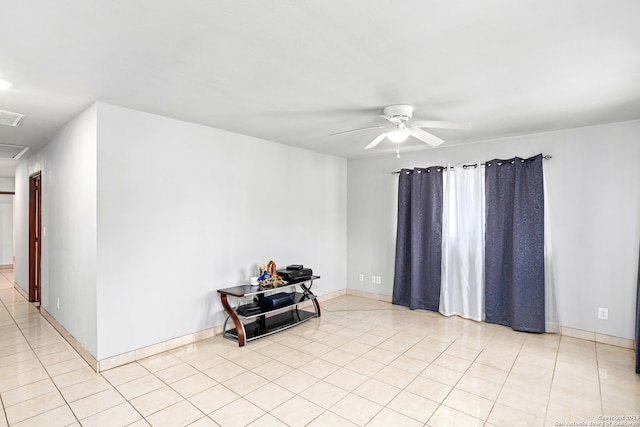 empty room featuring ceiling fan and light tile floors