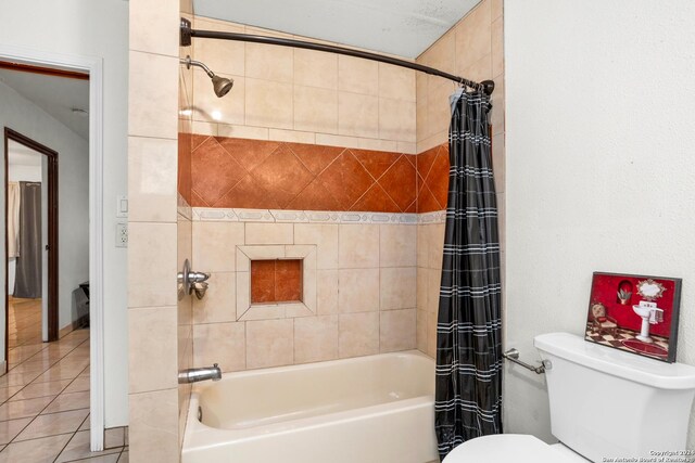 bathroom with tile flooring, toilet, and shower / bath combo