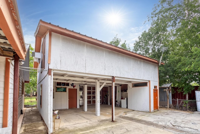 exterior space featuring an outdoor structure, a detached garage, and fence