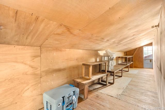 bonus room with wood ceiling, wood walls, vaulted ceiling, and light hardwood / wood-style flooring