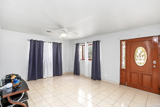 foyer entrance featuring ceiling fan, visible vents, baseboards, and light tile patterned flooring