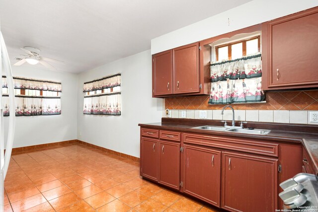 kitchen with sink, ceiling fan, tasteful backsplash, and light tile flooring