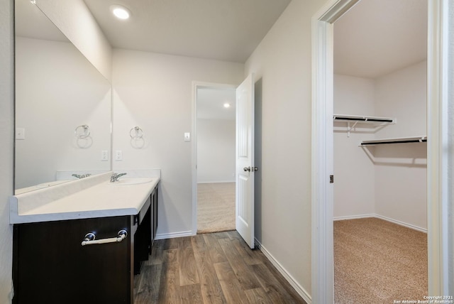 bathroom with hardwood / wood-style flooring and vanity