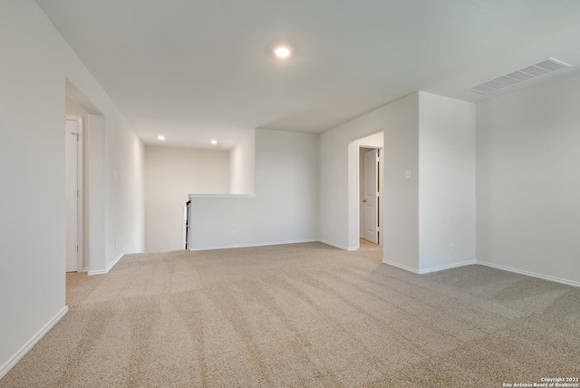 unfurnished room featuring light colored carpet