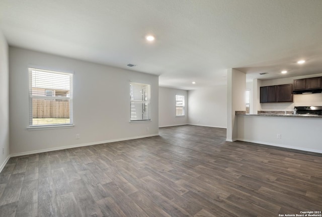 unfurnished living room with dark wood-type flooring