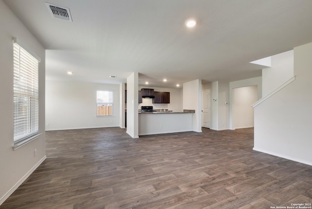 unfurnished living room with dark hardwood / wood-style flooring