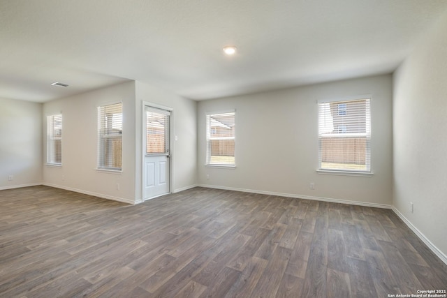 spare room with dark wood-type flooring