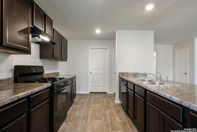 kitchen featuring dark brown cabinetry, sink, black appliances, and light hardwood / wood-style floors