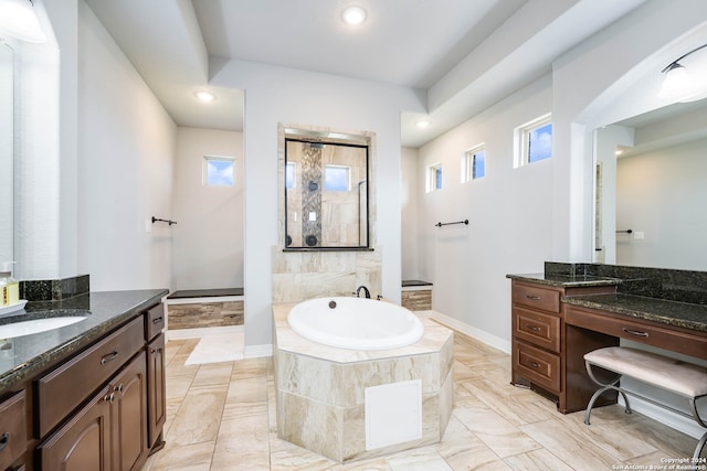 bathroom with tile floors, a relaxing tiled bath, and dual bowl vanity