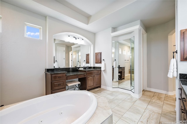 bathroom with tile flooring, dual vanity, and a bathing tub