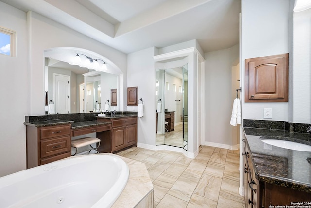 bathroom featuring vanity and tiled tub