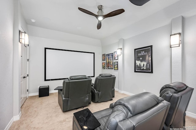 home theater room with light colored carpet and ceiling fan