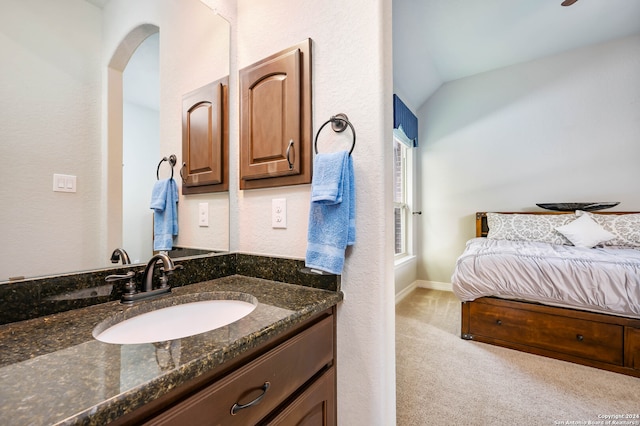 bathroom featuring vaulted ceiling and vanity