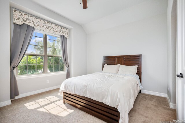 carpeted bedroom with lofted ceiling and ceiling fan