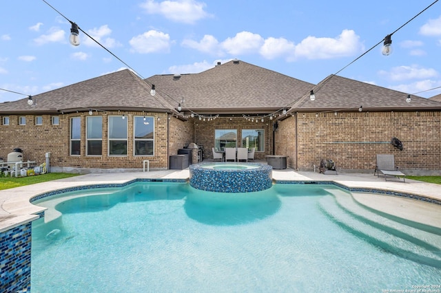 view of pool featuring an in ground hot tub and a patio area