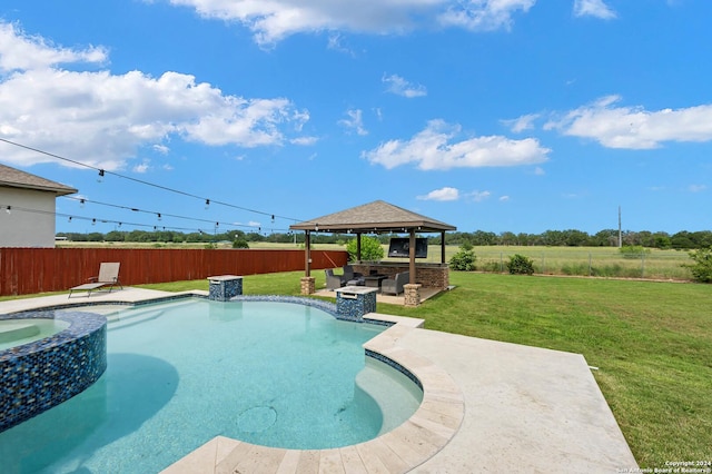 view of swimming pool featuring a patio, a yard, an in ground hot tub, and a gazebo