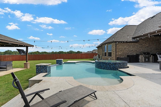 view of pool featuring an outdoor kitchen, a patio area, a gazebo, a lawn, and an in ground hot tub