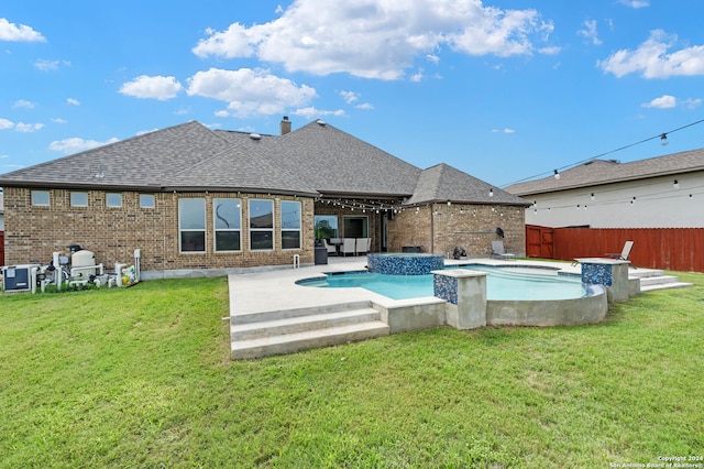 view of swimming pool with a patio, central AC, an in ground hot tub, and a yard