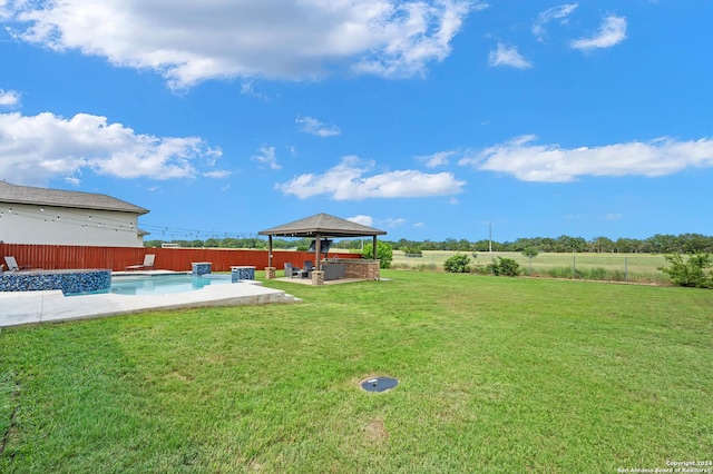 view of yard featuring a fenced in pool, a gazebo, and a patio