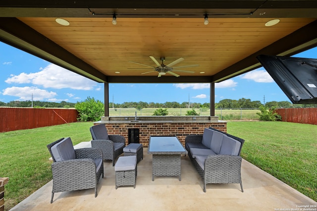 view of terrace with an outdoor living space and ceiling fan