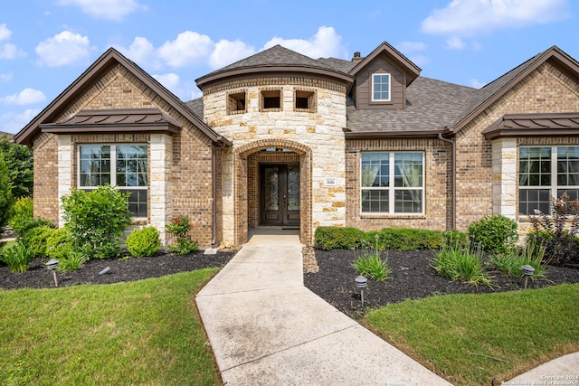 view of front of property featuring a front lawn and french doors