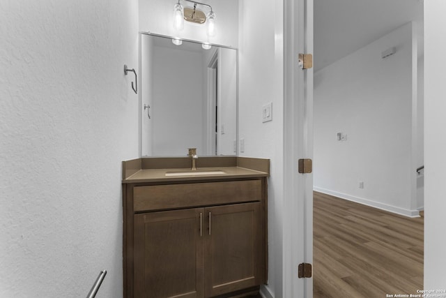 bathroom with hardwood / wood-style flooring and vanity